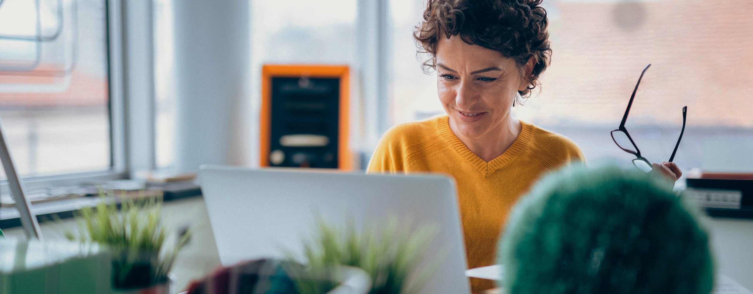 Woman smiling looking at laptop computer