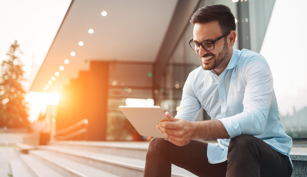 Man using tablet for digital banking.