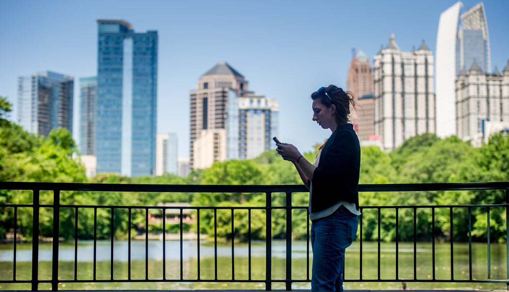 Woman looking at phone in Downtown Atlanta.